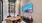 offices with windows, a tv and meeting tables with chairs
