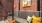 booth seating with a pillow and brick wall behind it