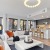 living room with large windows couches and coffee table