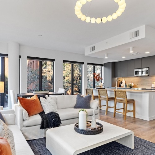 Generous living spaces to relax and unwind living room with large windows couches and coffee table