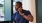 A man on the phone next to a window