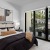large, high windows with patio view in bedroom