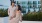 A man and a woman outside next to flower beds