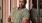 A man in a green shirt posing for a picture