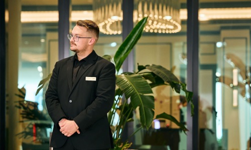 a concierge or man standing in a space