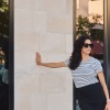 Woman leaning against storefront