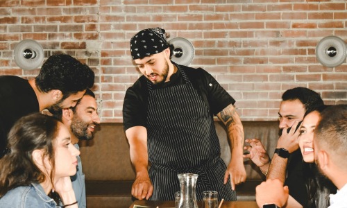 a chef and people laughing indoors